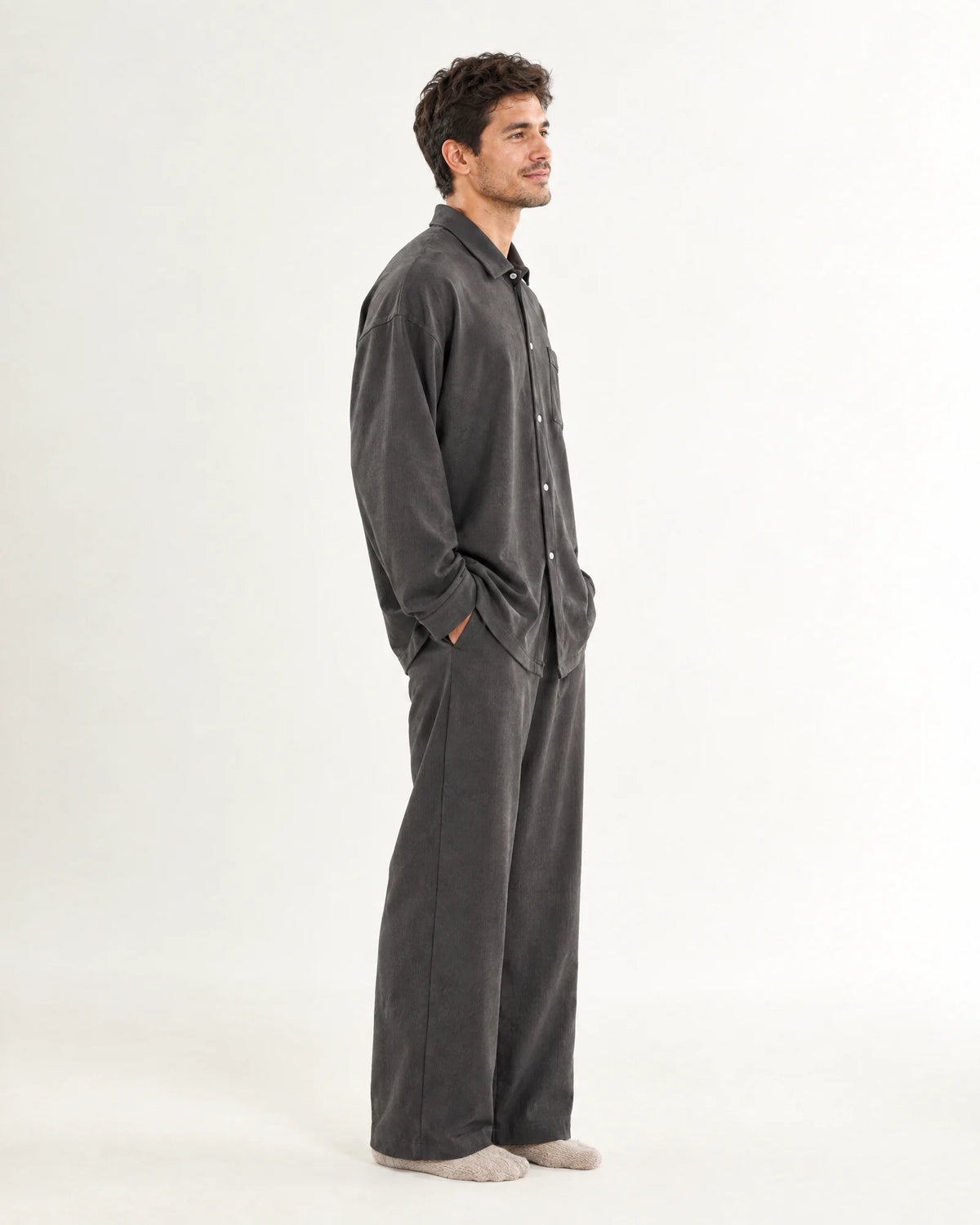 Side view of a woman wearing the grey CASUCA pet-hair-resistant loungewear set