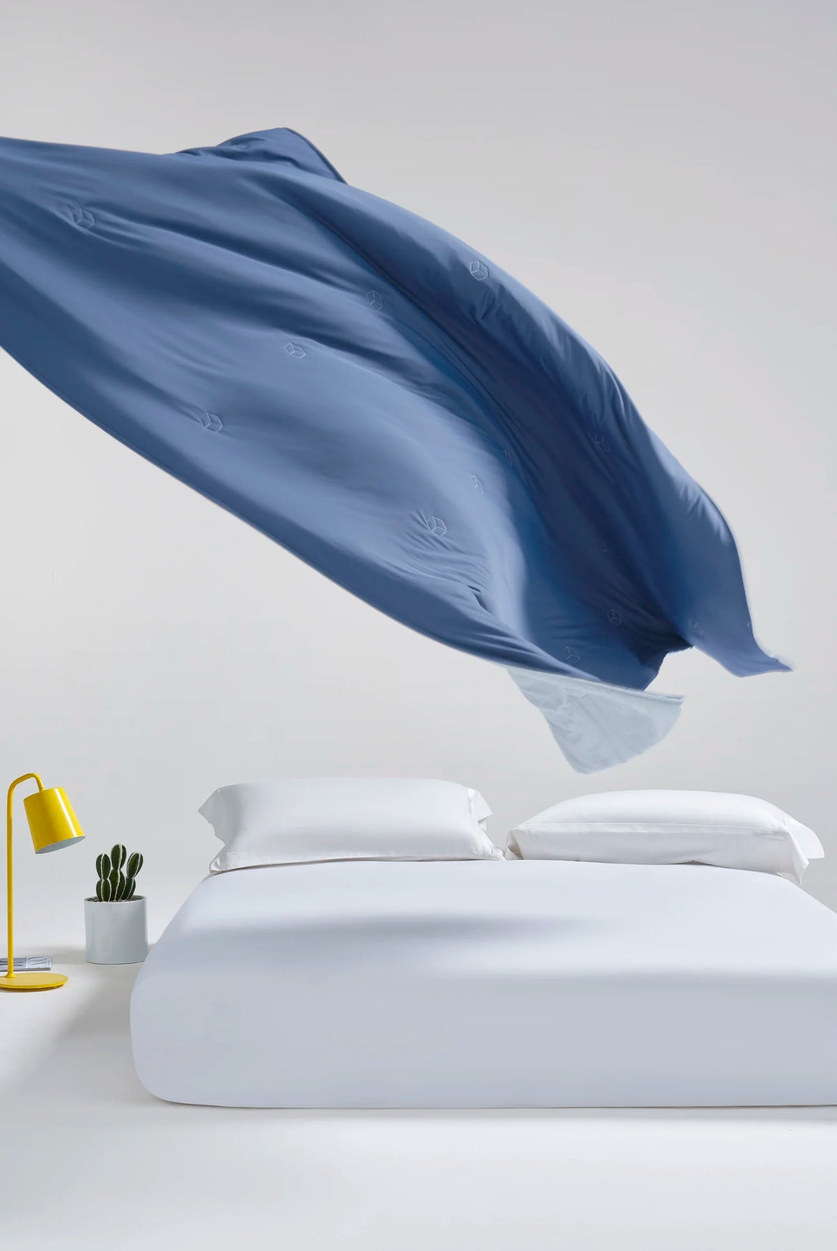 Prussian blue CASUCA cooling comforter displayed against a light background