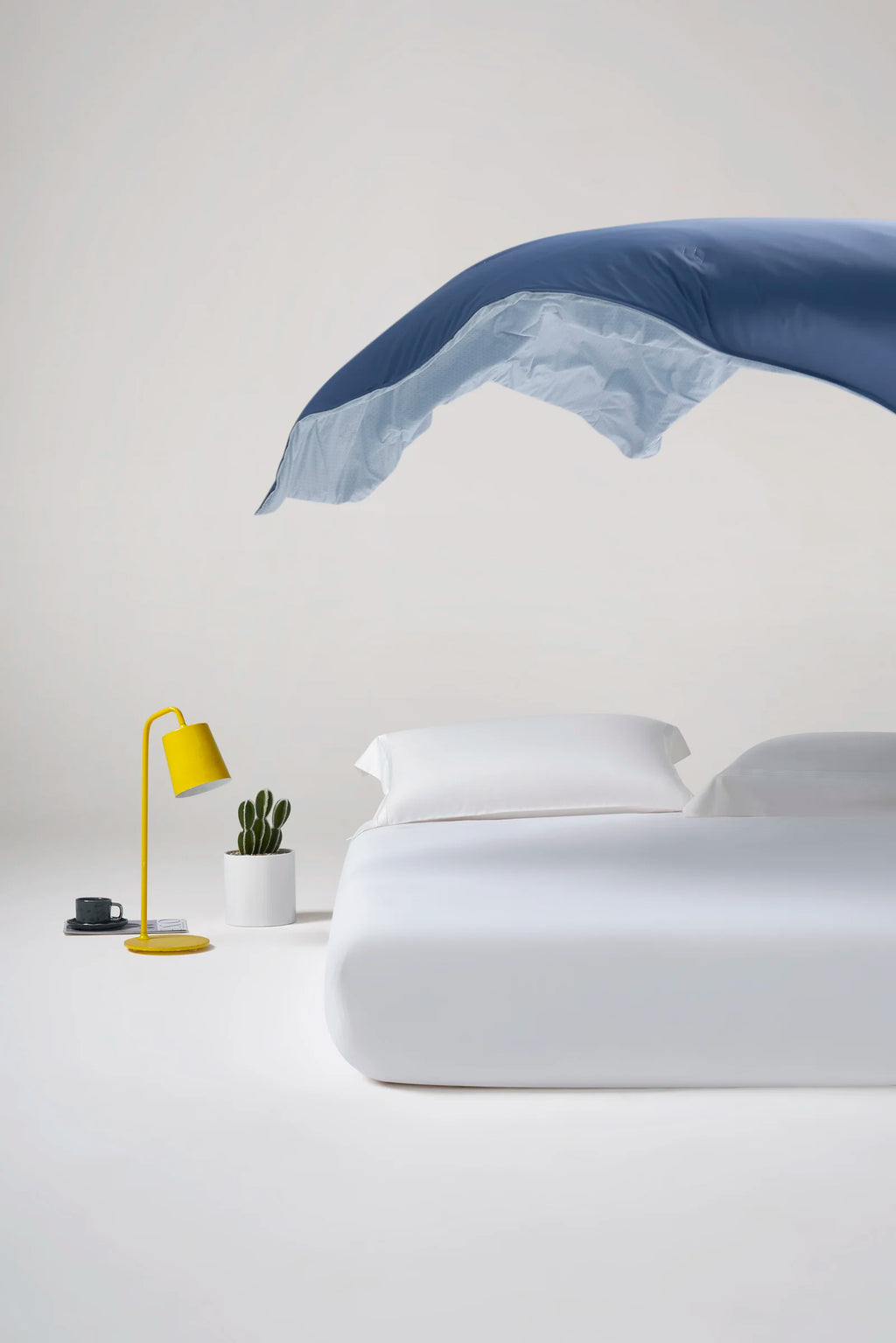 Reversible Prussian blue CASUCA cooling comforter showing both sides