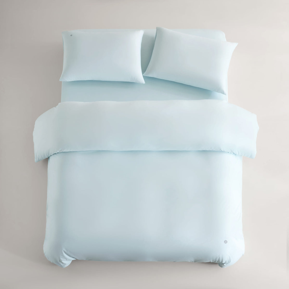 blue CASUCA cooling pet-hair-resistant bedding set styled in a pet-friendly bedroom