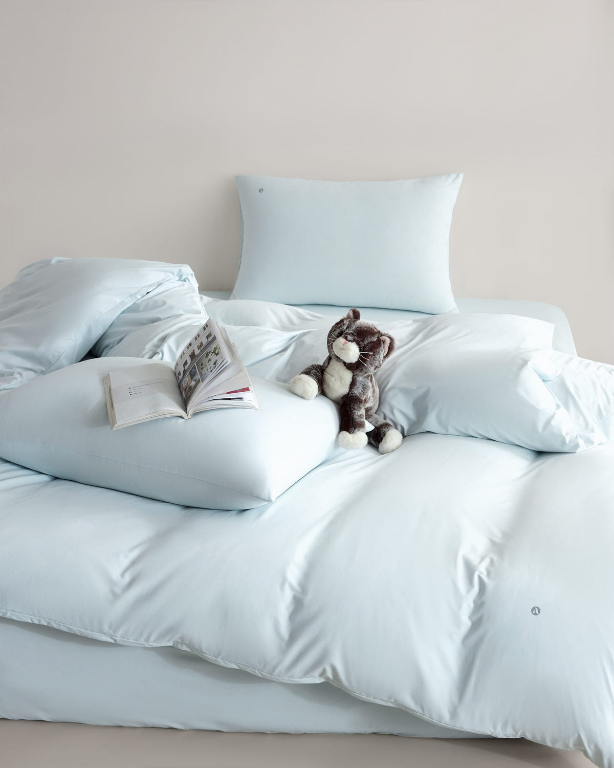 blue CASUCA cooling pet-hair-resistant bedding set styled in a pet-friendly bedroom