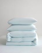Folded blue CASUCA cooling pet-hair-resistant bedding set