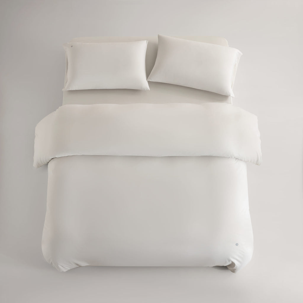 oatmeal CASUCA cooling pet-hair-resistant bedding set styled in a pet-friendly bedroom
