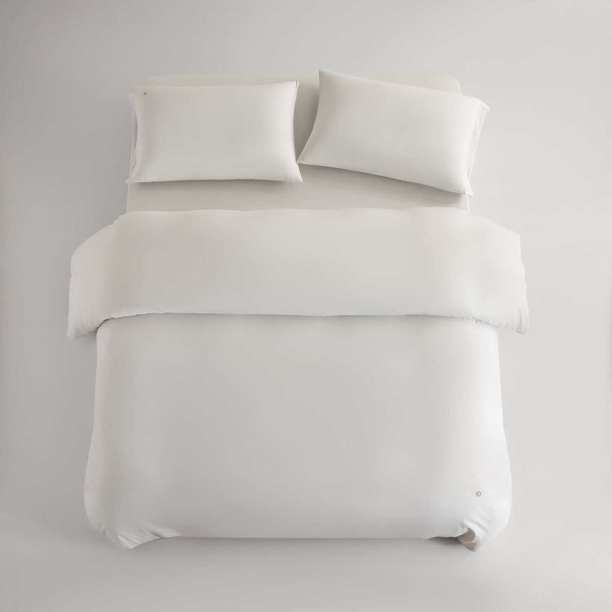 oatmeal CASUCA cooling pet-hair-resistant bedding set styled in a pet-friendly bedroom