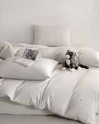 oatmeal CASUCA cooling pet-hair-resistant bedding set styled in a pet-friendly bedroom