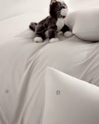 oatmeal CASUCA cooling pet-hair-resistant bedding set styled in a pet-friendly bedroom