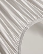 Fitted sheet elastic detail on the oatmeal CASUCA cooling pet-hair-resistant bedding set