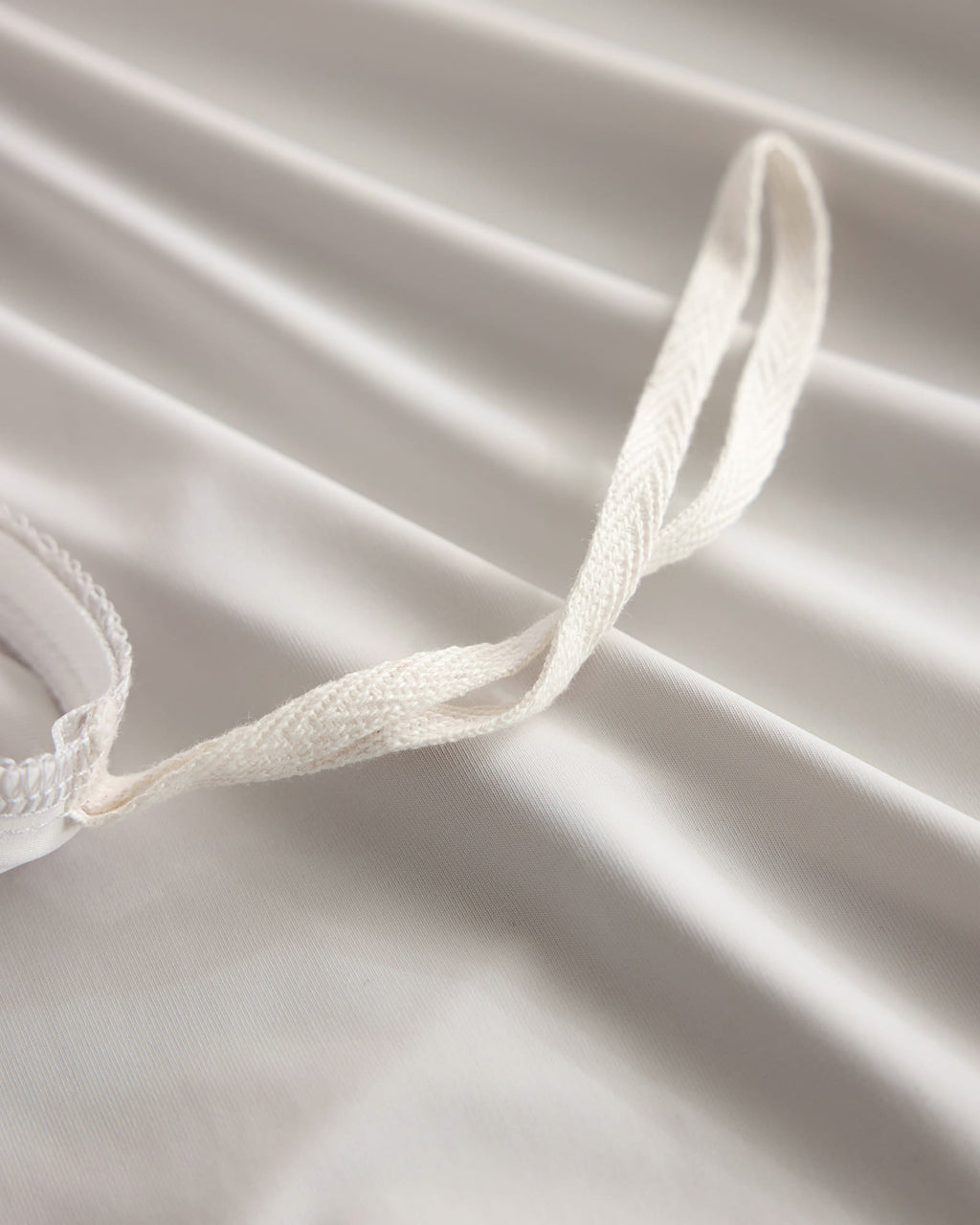 Duvet corner tie detail on the oatmeal CASUCA cooling pet-hair-resistant bedding set