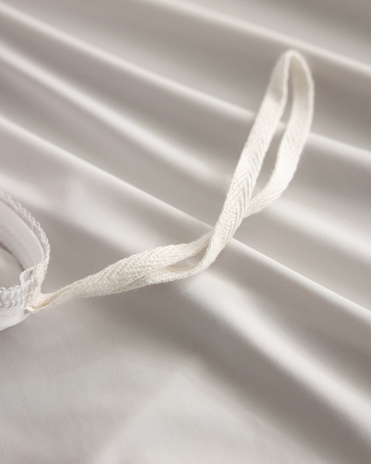 Duvet corner tie detail on the oatmeal CASUCA cooling pet-hair-resistant bedding set