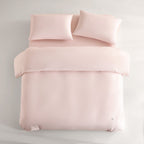 pink CASUCA cooling pet-hair-resistant bedding set styled in a pet-friendly bedroom
