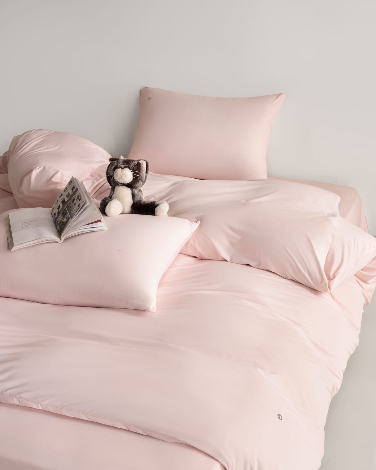 pink CASUCA cooling pet-hair-resistant bedding set styled in a pet-friendly bedroom