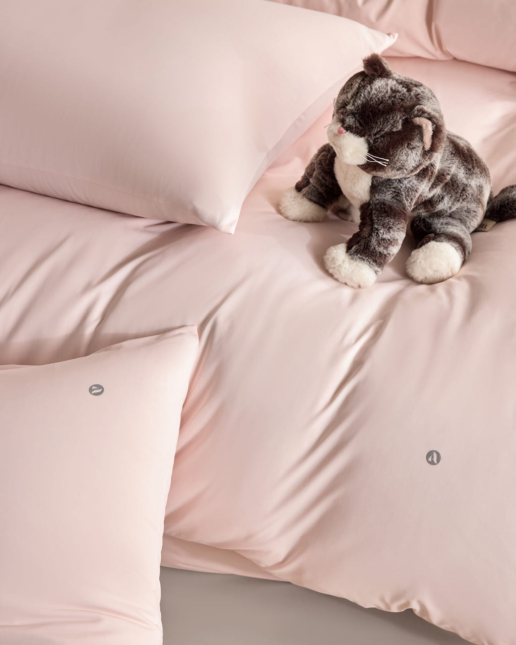 pink CASUCA cooling pet-hair-resistant bedding set styled in a pet-friendly bedroom