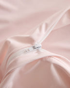 Concealed zipper detail on the pink CASUCA cooling pet-hair-resistant bedding set