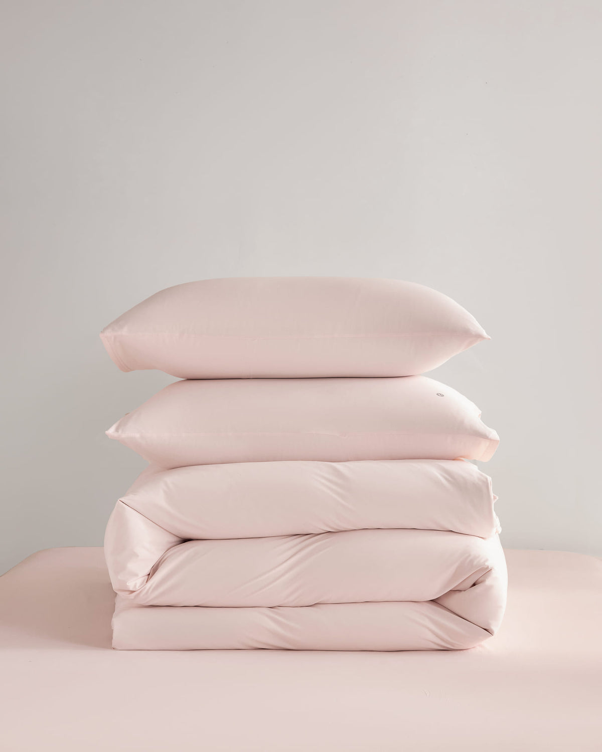 Folded pink CASUCA cooling pet-hair-resistant bedding set