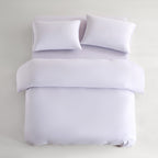 purple CASUCA cooling pet-hair-resistant bedding set styled in a pet-friendly bedroom
