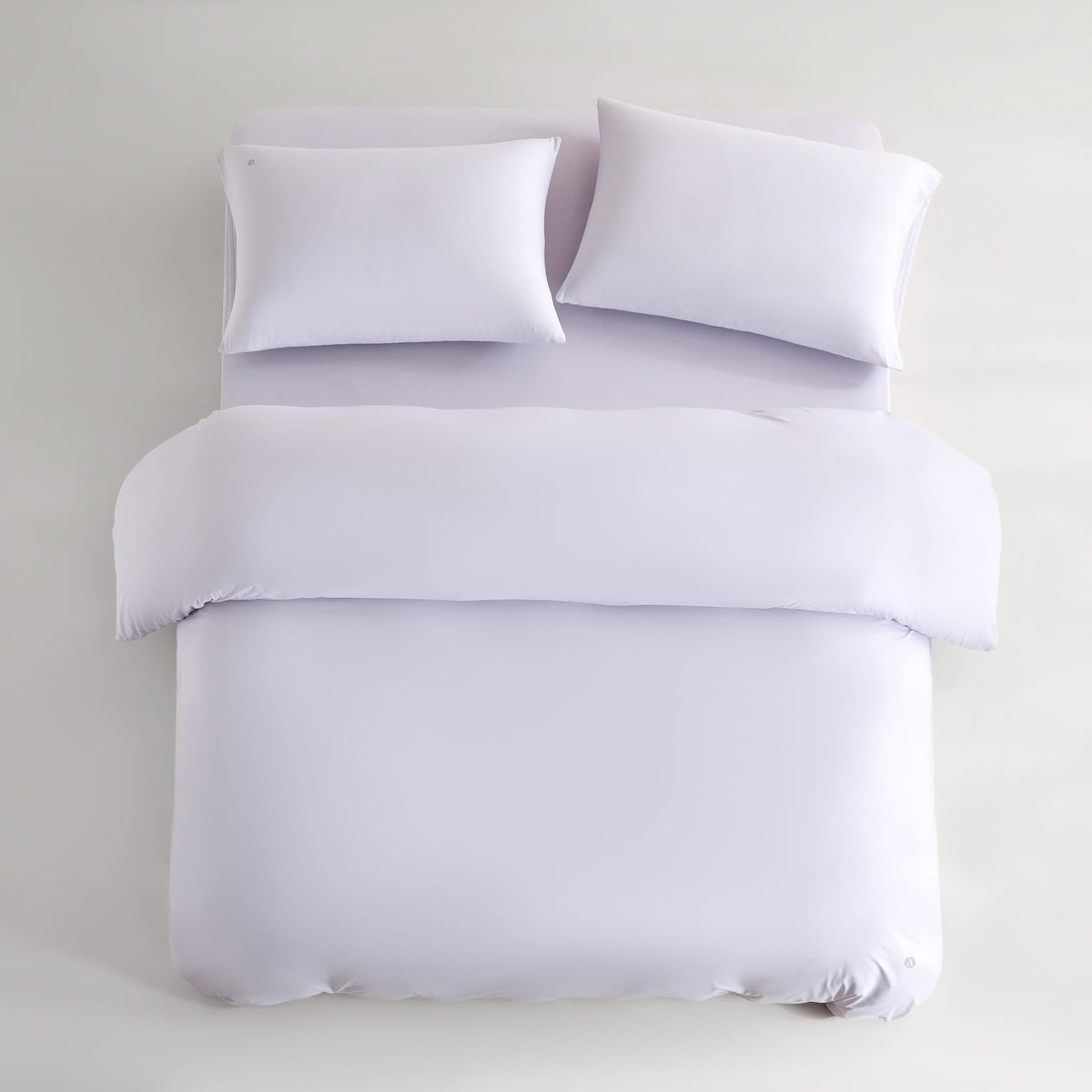 purple CASUCA cooling pet-hair-resistant bedding set styled in a pet-friendly bedroom