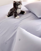 purple CASUCA cooling pet-hair-resistant bedding set styled in a pet-friendly bedroom