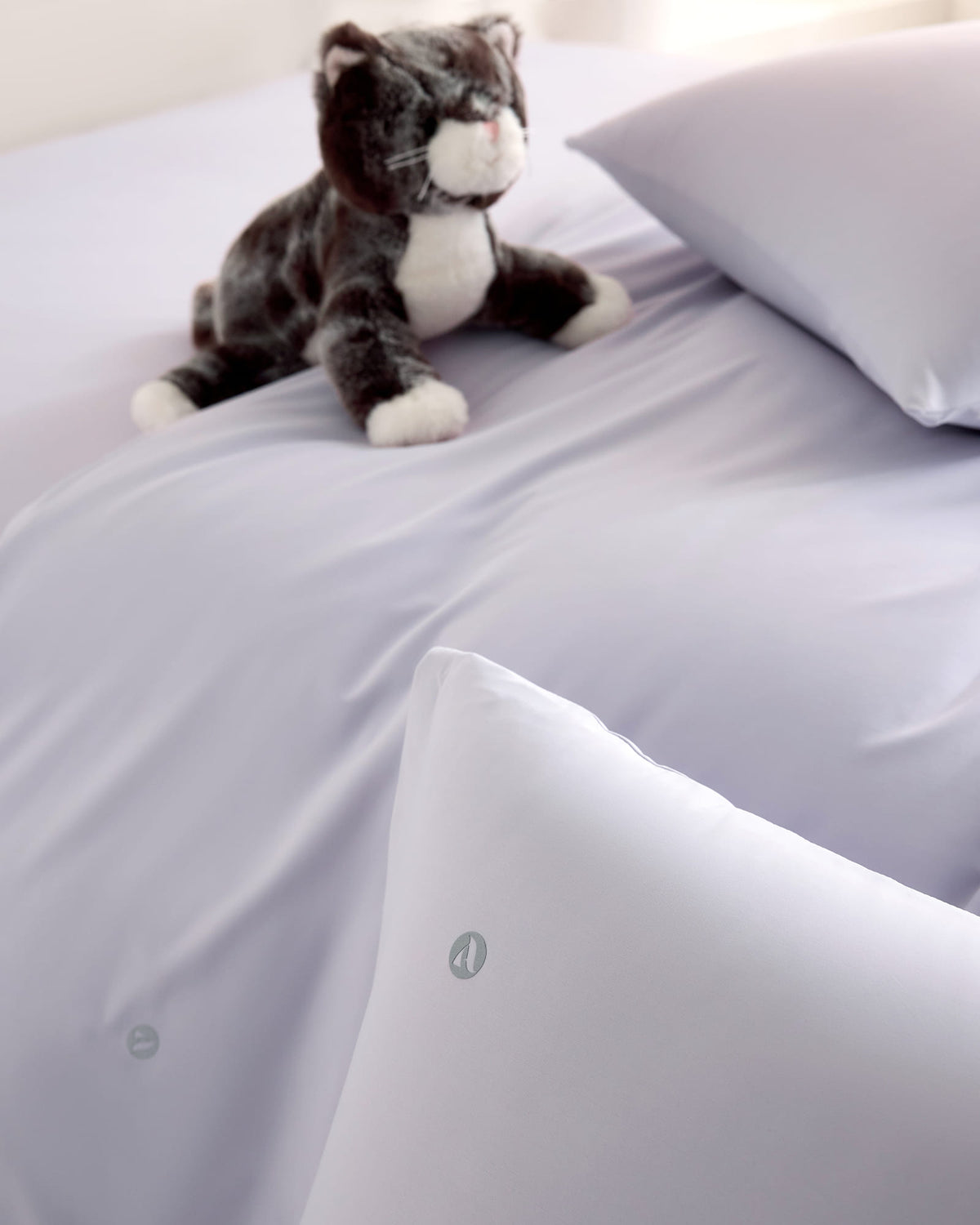 purple CASUCA cooling pet-hair-resistant bedding set styled in a pet-friendly bedroom