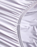 Fitted sheet elastic detail on the purple CASUCA cooling pet-hair-resistant bedding set
