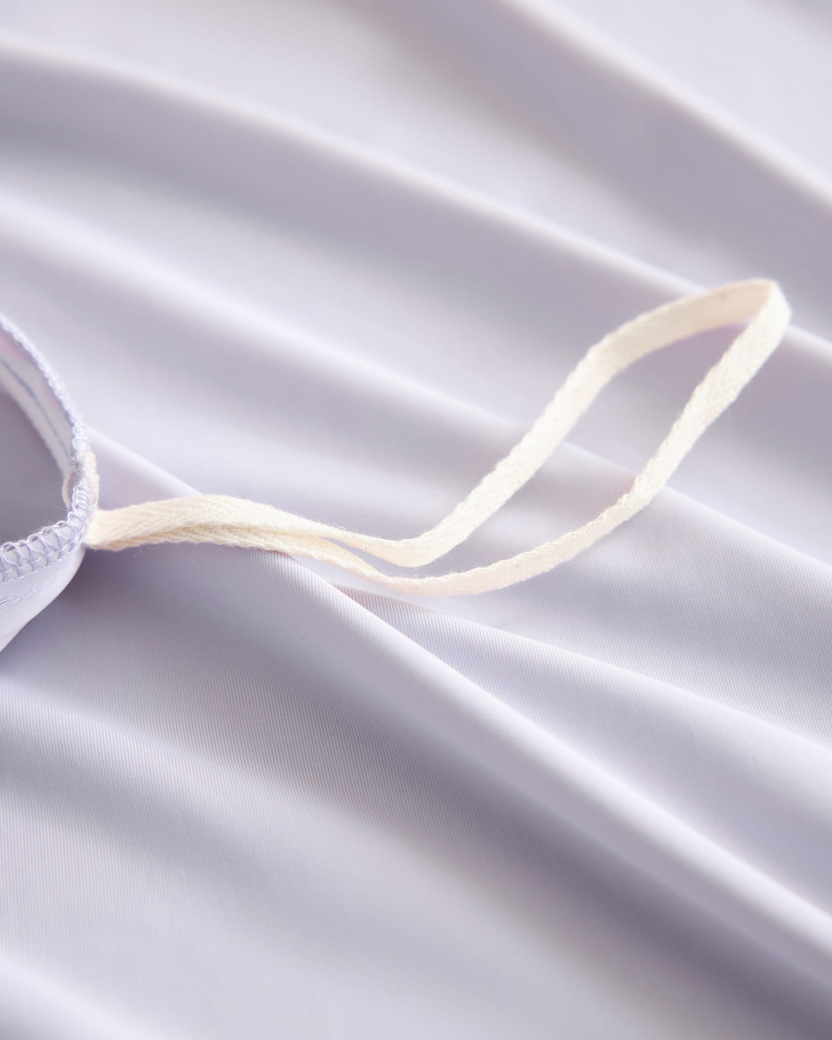 Duvet corner tie detail on the purple CASUCA cooling pet-hair-resistant bedding set